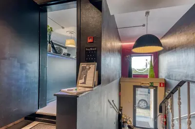 a hallway with a stairway with a door to a room at Hôtel de la Gare in Visé
