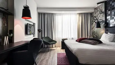 a hotel room with a bed and a desk and a desk at M Hotel in Genk