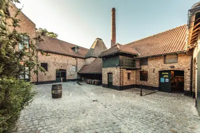 an empty courtyard of an old brick building at Holiday Inn Hasselt by IHG in Hasselt