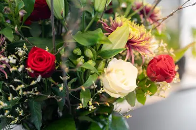 a bouquet of different colored flowers in a vase at Holiday Inn Hasselt by IHG in Hasselt