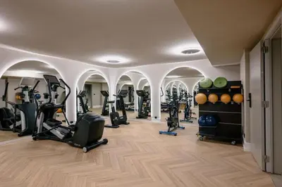 a gym with a bunch of exercise equipment in a room at Stiemerheide - The Urban Hotel & Golf Retreat 4 Star Superior in Genk