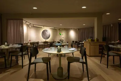 a restaurant with tables and chairs in a room at Stiemerheide - The Urban Hotel & Golf Retreat 4 Star Superior in Genk