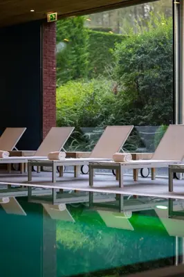 a row of tables in a pool of water at Stiemerheide - The Urban Hotel & Golf Retreat 4 Star Superior in Genk