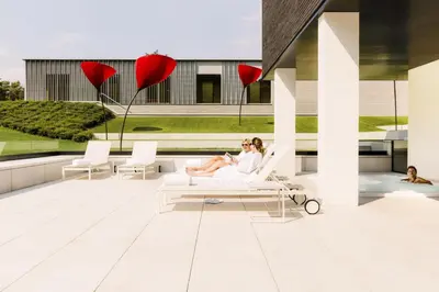two women sitting on the roof of a building at La Butte aux Bois a Small Luxury Hotel of the World in Lanaken