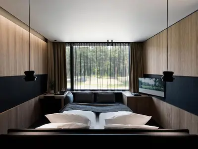 a bedroom with a large bed and a window at La Butte aux Bois a Small Luxury Hotel of the World in Lanaken
