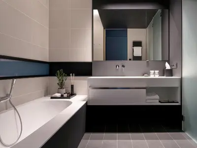 a bathroom with a tub and a sink and a mirror at La Butte aux Bois a Small Luxury Hotel of the World in Lanaken
