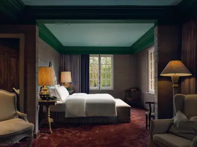a bedroom with a white bed and a window at La Butte aux Bois a Small Luxury Hotel of the World in Lanaken