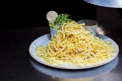 a plate of food with noodles on a table at Hotel The Century in Hasselt