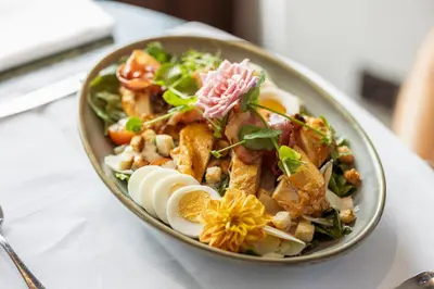 a salad in a bowl on a table at Hotel The Century in Hasselt