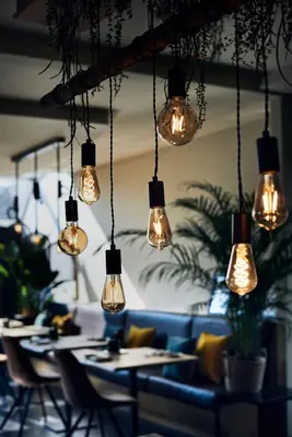 a group of lights hanging from the ceiling of a restaurant at Hotel Zuid in Genk