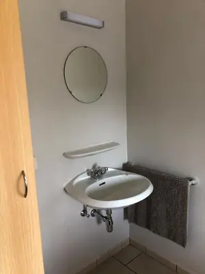 a bathroom with a sink and a mirror on the wall at d'Uyterwaerde in Leut