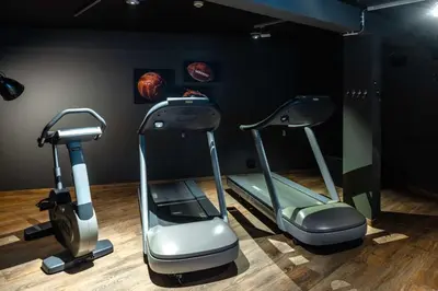 a gym with three exercise bikes in a room at pentahotel Liège in Liège