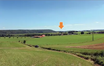a green field with a yellow arrow in the sky at Seven-Bedroom Holiday Home In Remersdaal in Remersdaal