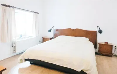 a bedroom with a bed and a window at Seven-Bedroom Holiday Home In Remersdaal in Remersdaal