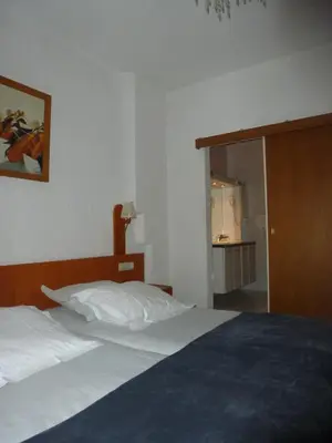 a bedroom with a bed and a sliding glass door at Hotel 'T Hert in Genk