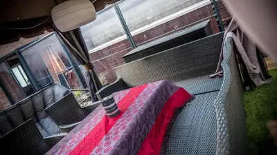 a table on a bus with a red blanket on it at Sérénité - Espace Détente Ensival in Ensival