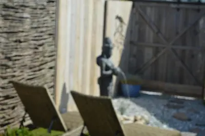 two chairs sitting on a patio next to a fence at Relax B&B Lavendine Pure in Genk