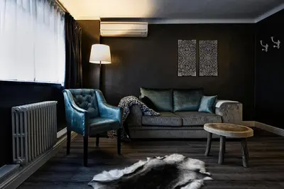 a living room with a couch and a chair at Hotel Mardaga in As