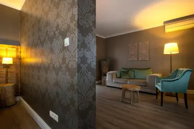 a living room with a couch and a table at Hotel Mardaga in As