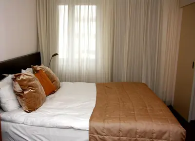 a bedroom with a bed with pillows and a window at Hotel Malpertuus in Riemst