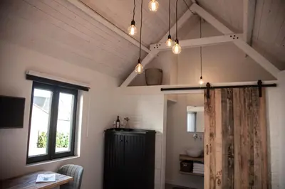 a bathroom with a sink and a window and lights at Belle Chique - Maastricht in Lanaken