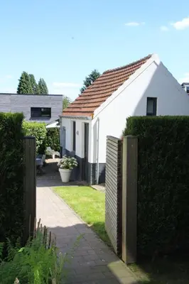 a white house with a fence in a yard at Belle Chique - Maastricht in Lanaken