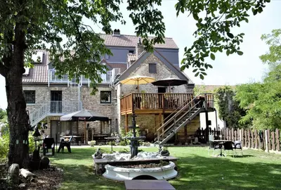 a house with a deck and a staircase in the yard at B&B De Dubbelmolen in Tongeren