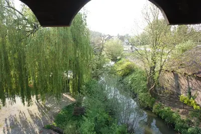 a view of a river under a bridge at B&B De Dubbelmolen in Tongeren