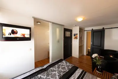a living room with a flat screen tv on a wall at B&B Montenakerhof in Riemst