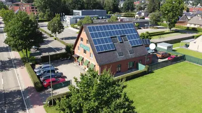an image of a house with solar panels on the roof at Hotel Het Buskruid in Lummen