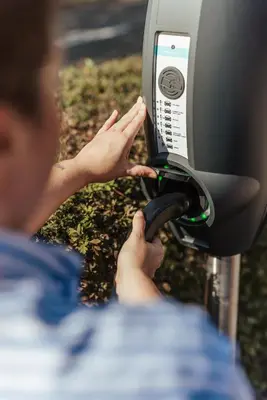 a person putting money into a pay phone at Hotel Het Buskruid in Lummen