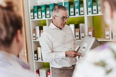 a man looking at his cell phone in a pharmacy at Hotel Het Buskruid in Lummen