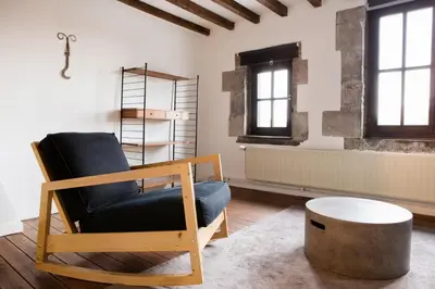 a living room with a chair and a table at Maison Sainte-Marguerite in Liège