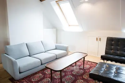 a living room with a couch and a coffee table at Maison Sainte-Marguerite in Liège