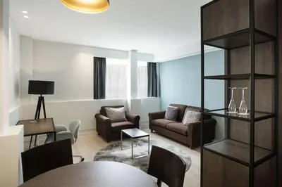 a living room with a table and chairs at Radisson Blu Hotel, Hasselt in Hasselt