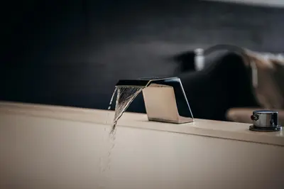 a stream of water is coming out of a sink at Carbon Hotel in Genk