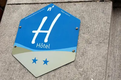 a blue and white sign sitting on the ground at Eurotel in Liège