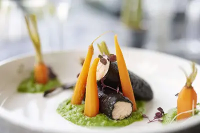 a plate of food with carrots and other vegetables at Park Inn by Radisson Liege Airport in Liège