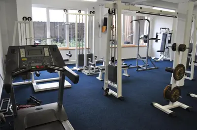 a gym with several tread machines and a simulator at Hotel Le Midi in Petit-Rechain