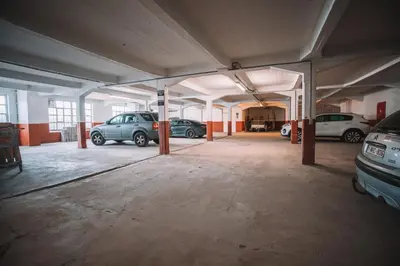 an empty parking lot with cars parked in it at Hotel Le Midi in Petit-Rechain