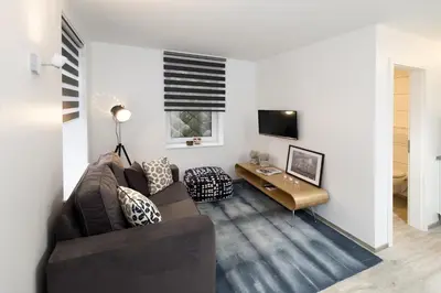 a living room with a couch and a table at Xperience-Today Eupen in Eupen