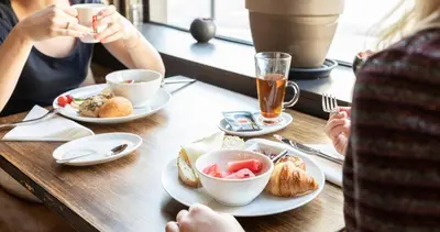 a group of people sitting at a table with food at Eburon Hotel in Tongeren