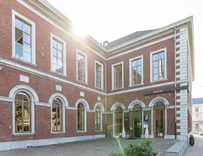a red brick building with windows and doors at Eburon Hotel in Tongeren