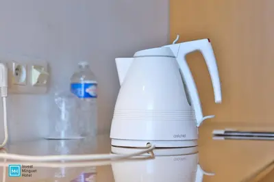 a white coffee maker sitting on top of a counter at Hotel De La Couronne Liege in Liège