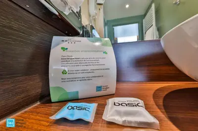a sign on a table with two toothbrushes on it at Hotel De La Couronne Liege in Liège