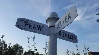 a street sign with two white street signs on it at 't Gulpdal Hotel Voeren-Teuven in Voeren