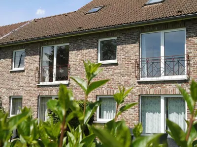 a red brick building with windows at 't Gulpdal Hotel Voeren-Teuven in Voeren