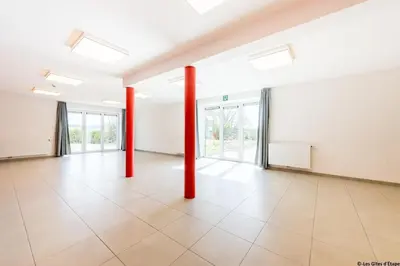 an empty room with red poles in a building at Gîte Kaleo Eupen Jugendherberge in Eupen