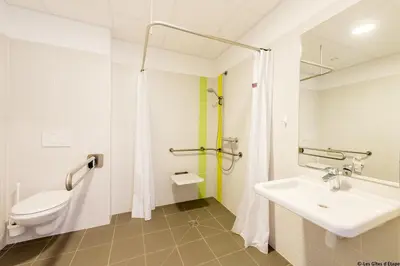 a bathroom with a toilet and a sink at Gîte Kaleo Eupen Jugendherberge in Eupen