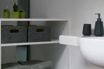 a bathroom shelf with a toilet and a sink at Wetterdelle in Heers